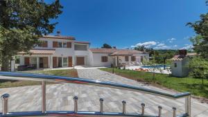 a villa with a swimming pool and a house at Villa Ana by Villas Holiday in Labin
