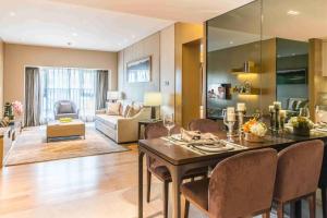 a dining room and living room with a table and chairs at Somerset Grandview Shenzhen in Shenzhen