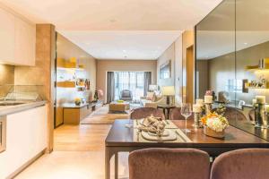 a kitchen and living room with a table and chairs at Somerset Grandview Shenzhen in Shenzhen