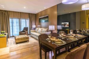 a living room with a dining table and a couch at Somerset Grandview Shenzhen in Shenzhen