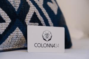 a white and black sign sitting on top of a pillow at Colonna 24 Luxury Room in Portovenere near 5 Terre in Portovenere