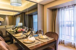a dining room with a table with wine glasses at Somerset Grandview Shenzhen in Shenzhen