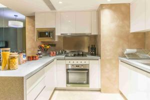 a kitchen with white cabinets and a stove top oven at Somerset Grandview Shenzhen in Shenzhen