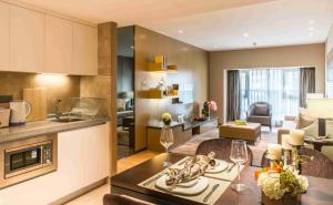 a kitchen and living room with a table in a room at Somerset Grandview Shenzhen in Shenzhen