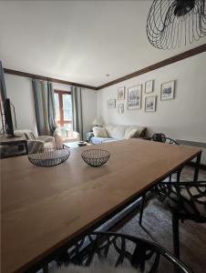 a living room with a wooden table with two bowls on it at Appartement Manoir de Savoie Arc 1950 in Bourg-Saint-Maurice