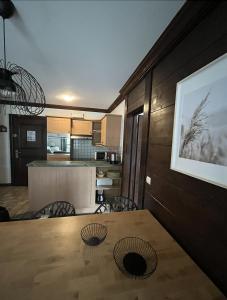 a dining room with a table and a kitchen at Appartement Manoir de Savoie Arc 1950 in Bourg-Saint-Maurice