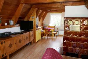 a living room with a television and a dining room at Reetdachhaus in Quilitz auf Usedom in Quilitz