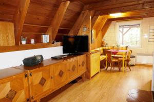 a living room with a television and a dining room at Reetdachhaus in Quilitz auf Usedom in Quilitz