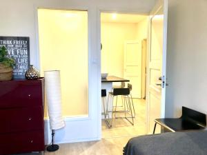 a bedroom with a sliding door leading to a dining room at Scandinavian Desing Home 37 City Center in Kamppi in Helsinki