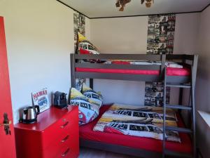 a bedroom with two bunk beds and a red dresser at Gasthaus Paula in Üdersdorf +40 photos