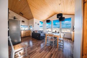 Blue View Cabin 6A With private hot tub في ريكهولت: مطبخ وغرفة معيشة مع طاولة وكراسي