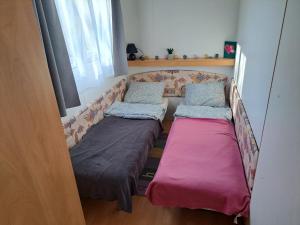 a couch with two beds in a room at Lexi Zen House in Kamnik