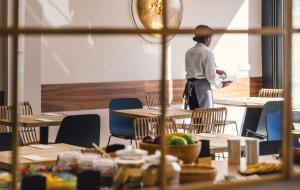 a man standing in a room with tables and chairs at Select Porto in Porto +30 photos