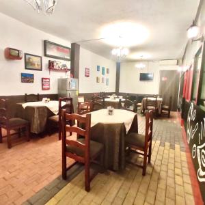 a dining room with tables and chairs in a restaurant at Hotel - Bravo Grand Hotel in Quevedo
