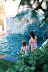 a woman and a child in a swimming pool at Indigo by The Oyster Collection in Kenton on Sea