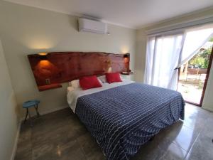 a bedroom with a bed with a large wooden headboard at Quinta el Rosal in Parral