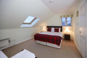 a bedroom with a bed and a skylight at Hillhead Farm Lets in Stirling