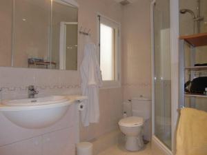 a bathroom with a toilet, sink and tub at Altissim Apartments in Pas de la Casa