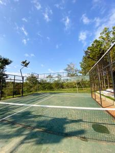 a tennis court with a net at Puma Resort Hotel in Doctor Juan León Mallorquín