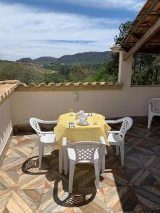 a table and chairs on a patio with a view at Astral de Minas in Tiradentes