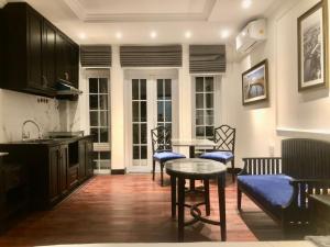a living room with a table and chairs and a kitchen at My Stay Hotel & Apartment in Ho Chi Minh City