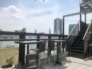 a table and chairs on a balcony with a view of the city at My Stay Hotel & Apartment in Ho Chi Minh City