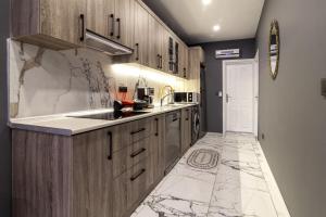 a kitchen with wooden cabinets and a marble floor at Amazin in Istanbul