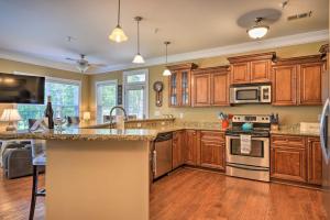 a kitchen with wooden cabinets and a counter top at Sunset Cove Condo Access to Lake Sinclair in Sparta