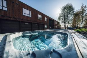 a hot tub in front of a building at Blue Hotel Fagrilundur - On The Golden Circle in Reykholt