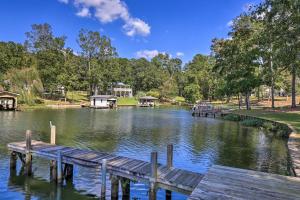a dock on a lake with houses in the background at Sunset Cove Condo Access to Lake Sinclair in Sparta