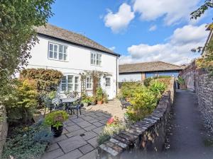 a house with a garden and a patio at Baytree Cottage, Walberton in Walberton