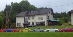 a group of cars parked in front of a building at Pension Hilberath in Kottenborn