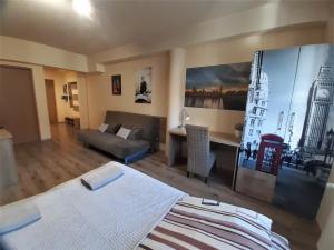 a bedroom with a bed and a desk and a couch at Pokoje Za Kinem in Duszniki Zdrój