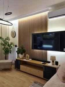 a living room with a large flat screen tv on a wall at Malta Premium Apartment, free parking, self check-in 24h in Poznań