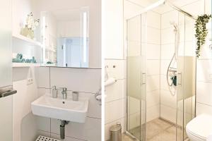 a white bathroom with a sink and a shower at fewo1846 Strandresidenz Wassersleben - OstseeNest - modernes Studioapartment mit Balkon am Strand in Harrislee