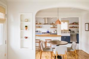 a kitchen and dining room with a table and chairs at Vine and View Cottage in Newberg