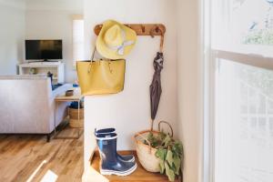 a living room with a hat and boots on a wall at Vine and View Cottage in Newberg