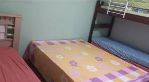 En eller flere senge i et værelse på Casa Oásis em Peruibe.