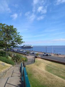 a view of a beach with a pier in the background at Poplar House in Cleethorpes