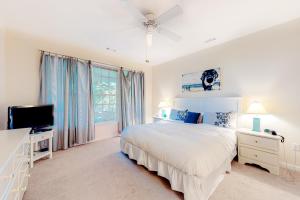 a white bedroom with a bed and a tv at Bear Trap - 54 H October Glory in Ocean View