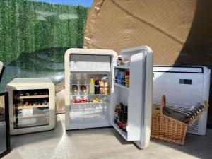 a white refrigerator with its door open next to another refrigerator with its door open at Sierra Salvada Bubbles in Salmantón