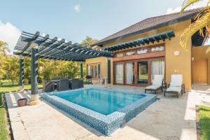 a swimming pool in the backyard of a house at Fabulous villa with picuzzi at Green Village B843 in Punta Cana