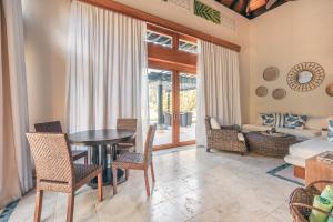 a living room with a table and chairs and a couch at Fabulous villa with picuzzi at Green Village B843 in Punta Cana