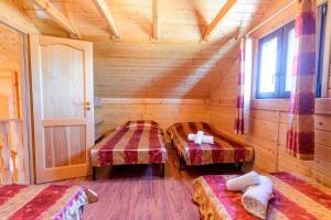 a room with three beds in a wooden cabin at House with Private Pool (Piscis) in Arenas