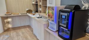 a kitchen with a cash counter with a video game machine at Appart'Hotel Festival Sud Aqua - Avignon TGV in Avignon