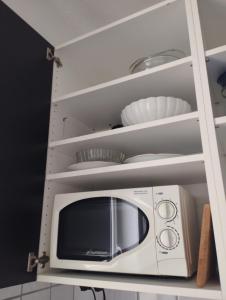 a microwave oven sitting inside of a kitchen cabinet at SUNNY SIDE in Kiel