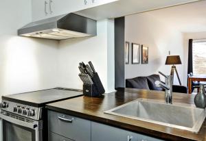 a kitchen with a sink and a stove at Hameau 24#22 - Studio in Stoneham