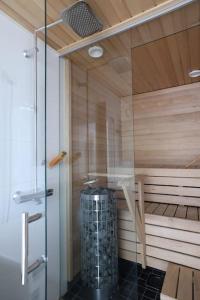 a sauna with a shower with a glass door at 2ndhomes Unique 35m2 Studio Penthouse with Sauna & Balcony in Helsinki