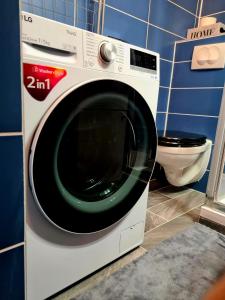 a washing machine in a bathroom with a toilet at Hookah Apartment 13 in Budapest