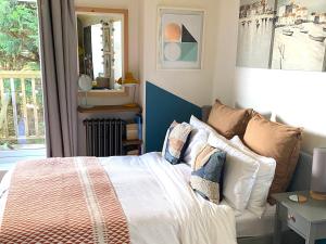 a bedroom with a bed with pillows and a window at St Ives Balcony Flat TreCar in St Ives